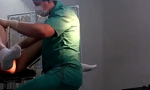 A girl in washed out socks on a gynecological chair
